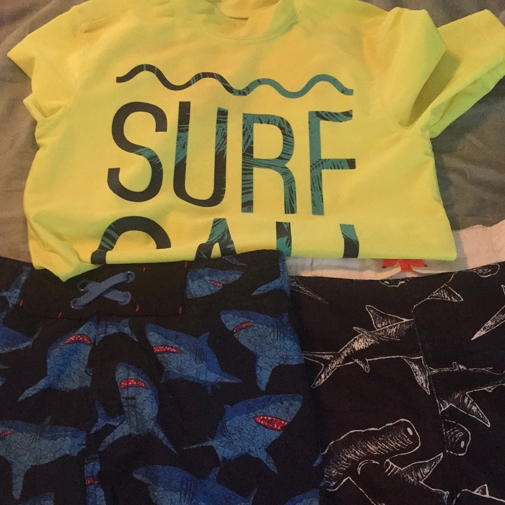 Combo of boy swim shorts and spf rash guard .